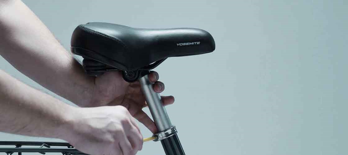 Adjusting bicycle saddle using Biltema tools while setting seat post and saddle height on a bike.